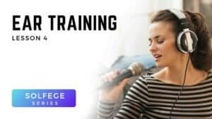 Woman singing with headphones and microphone during Voice 360 Solfège Series ear training lesson