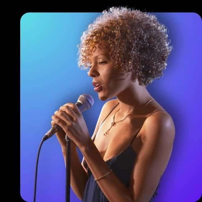 Female professional singer performing live on stage with microphone