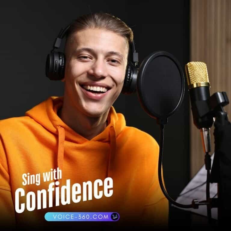 Young male singer recording vocals in studio with headphones and microphone